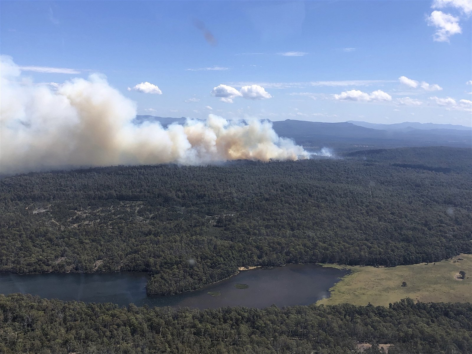 an aerial shot of smoke from a fire at central highland.